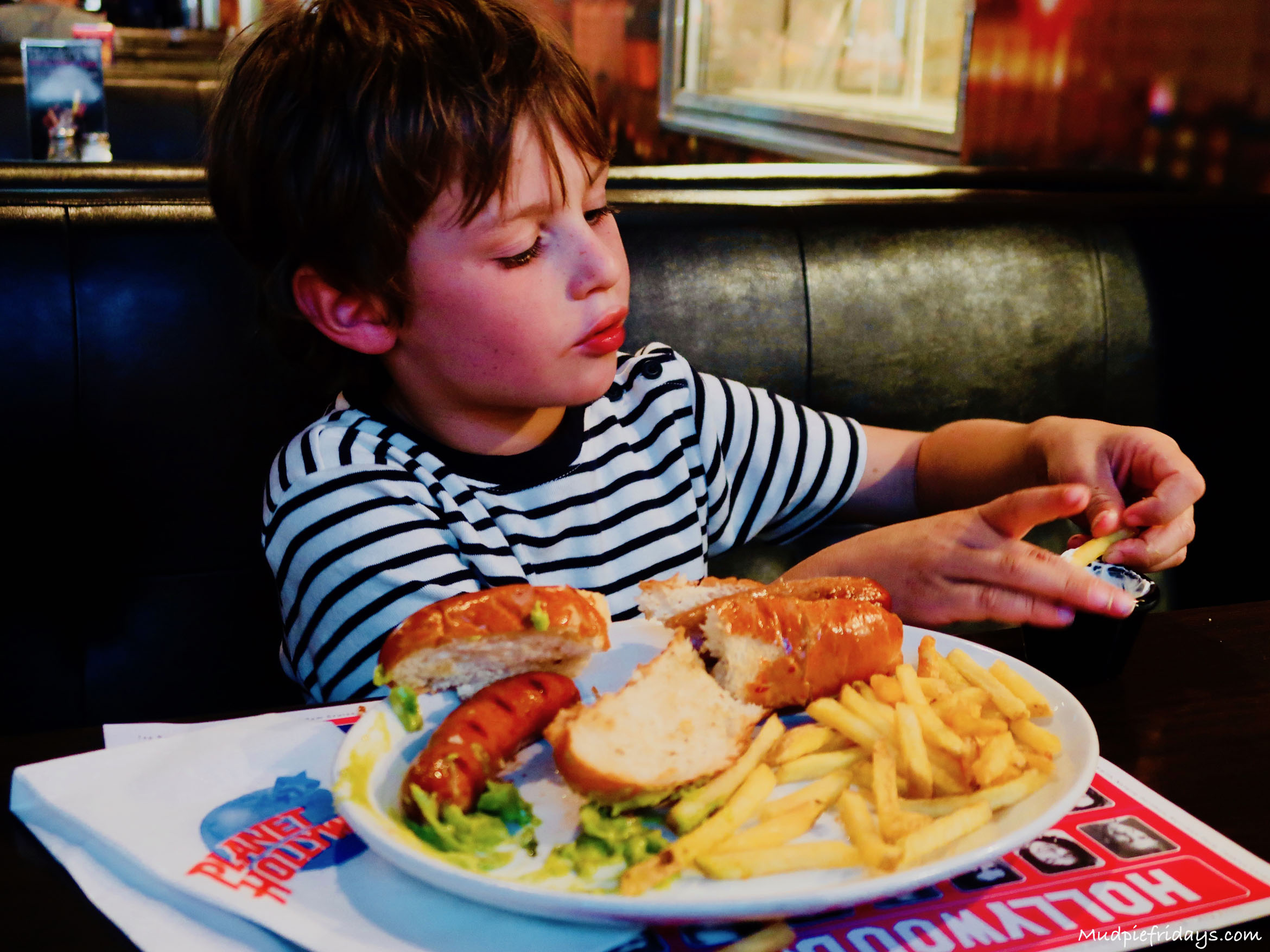 child eating hotdogs in a restaurant
