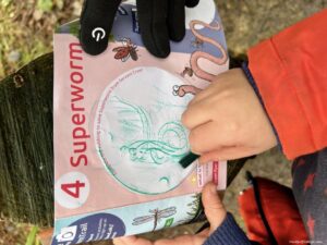 Doing a crayon rubbing on the Alice Holt Superworm trail