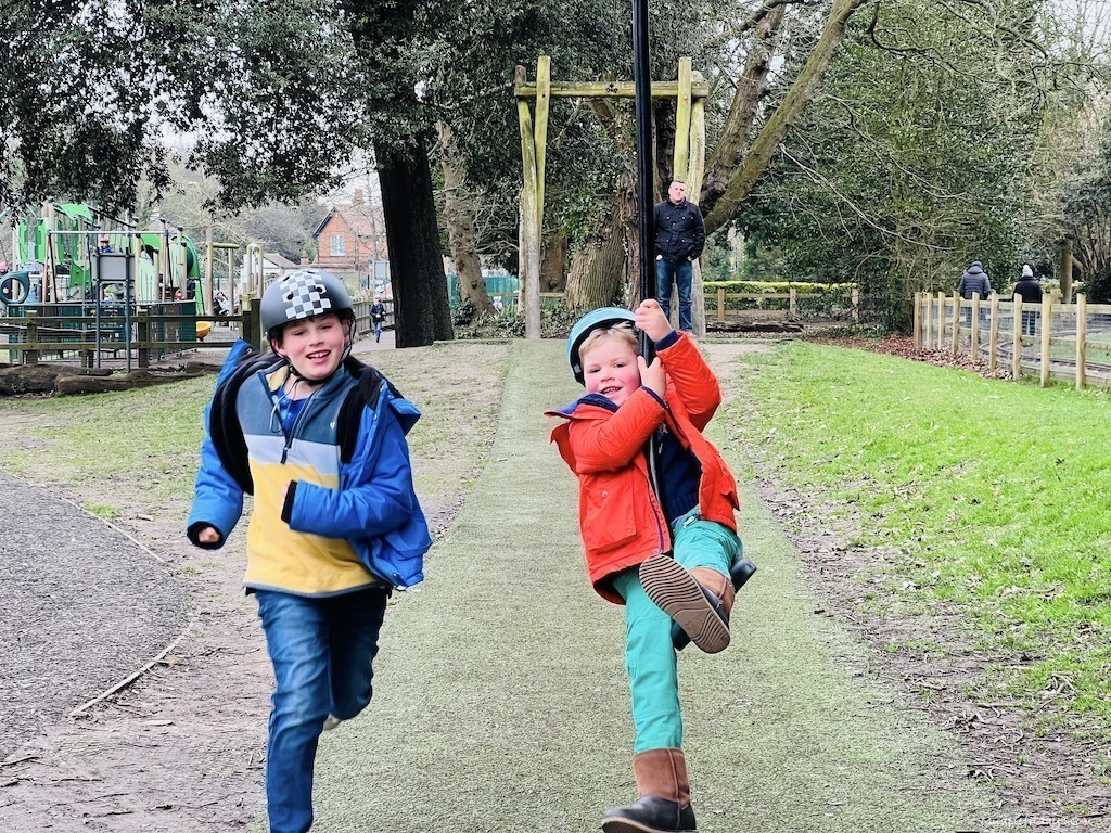 The boys playing on the zipline at the park in a park in bognor regis