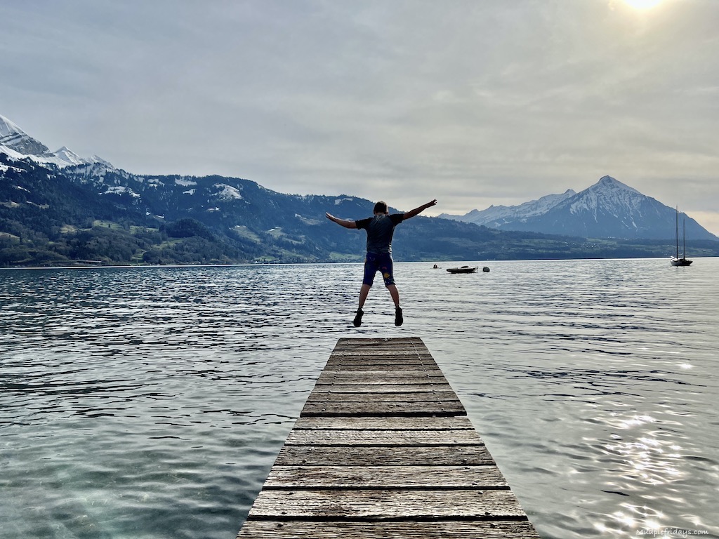 jumping off a wooden pier into Lake Thun - family holidays in Switzerland