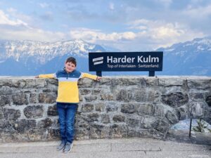 Standing next to the sign at the top of Harder Kulm top of Interlaken