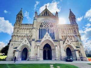 St albans cathedral with the sun rising behind it