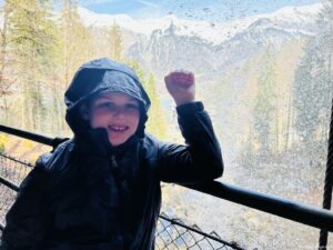 Charlie standing under the Switzerland waterfall