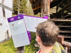 Charlie looking at all the information that is available on the properties at the Swiss open air museum