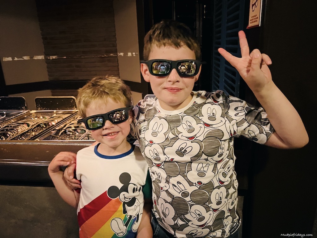 the boys waiting to go on a 4d ride at disney paris