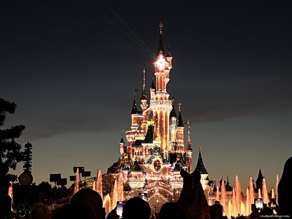Day trip to Disneyland paris castle all lit up at the illuminations in the evening