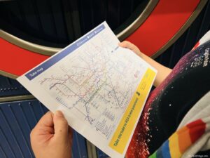 At home printed london tube map in front of a tube sign