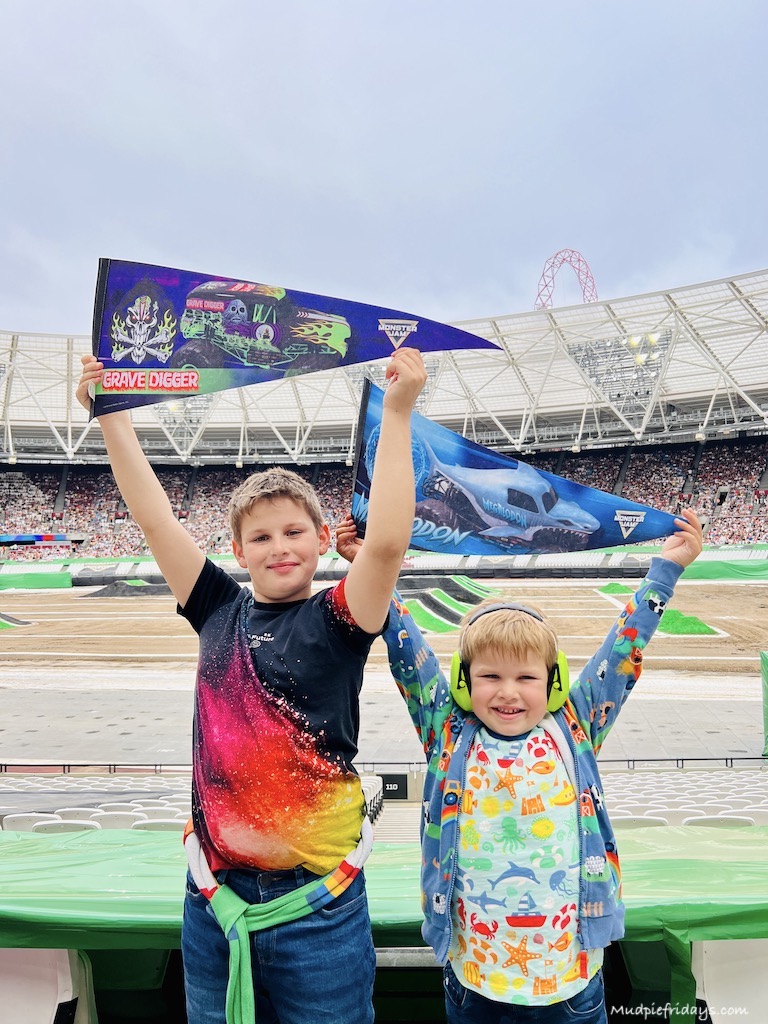 The boys with their flags at monster jam london stadium we have a grave digger supporter and a megaladon supppoter