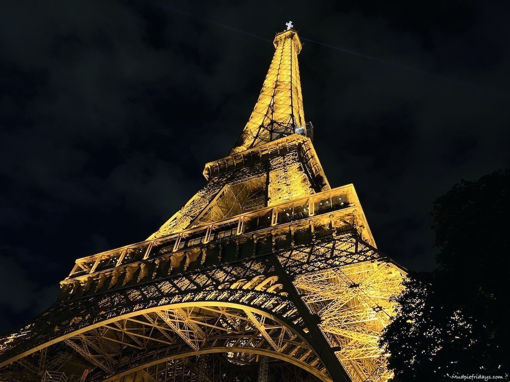 The Eiffel Tower by night all lit up from the bottom