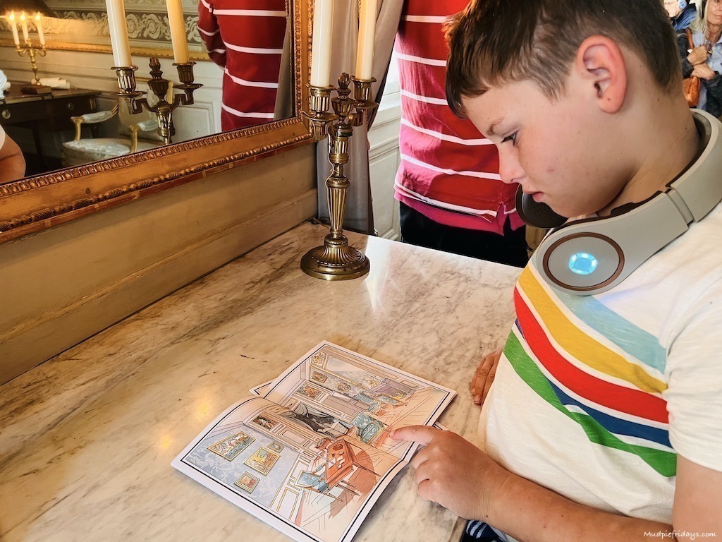 Charlie trying out the kids booklet on the audio tour