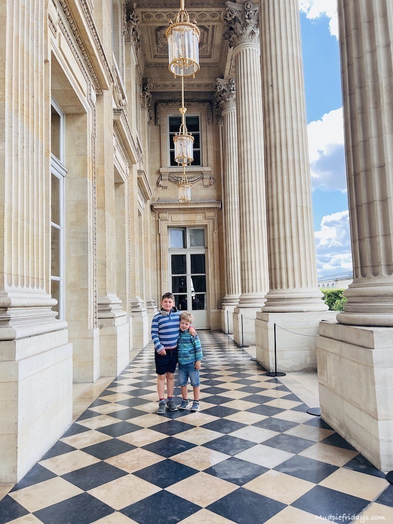 The Loggia at Hôtel de la Marine Paris with its roman pillars, black and white tiled floors and high ceilings