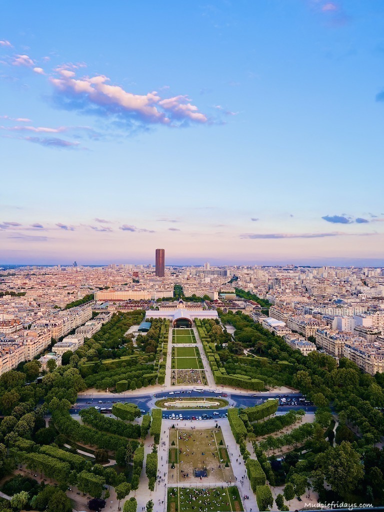 Photo from the second floor of the Eiffel Tower over looking the Eiffel Tower gardens as the sun is starting to set