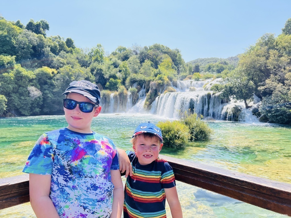 The boys in front of skradinski buk on the wooden bridge where you can pose for photos