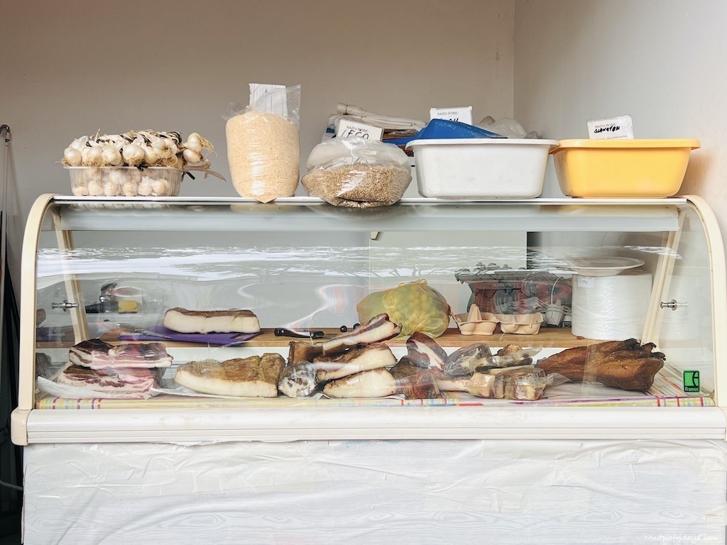 small refrigerator at the markets in split selling cheese and meat