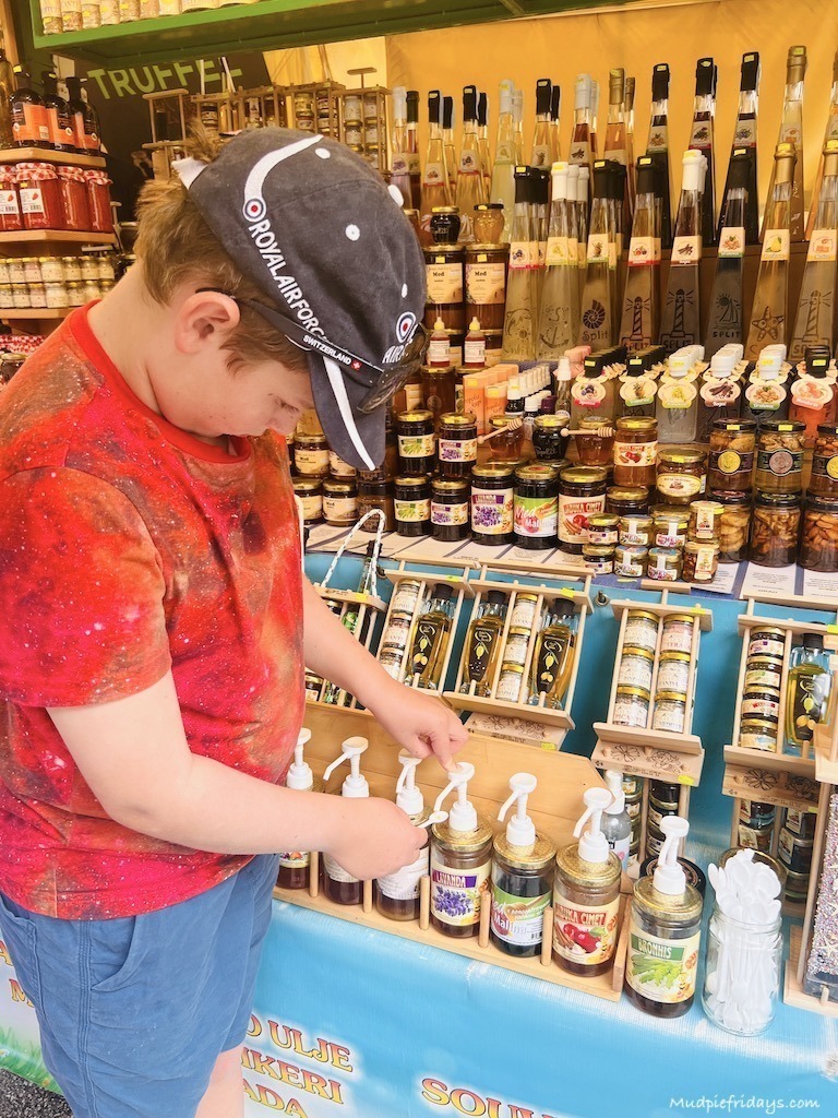 Charlie trying out the local honey at the markets in Split