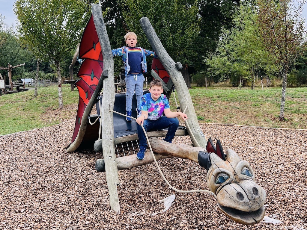 the boys on a wooden dragon at Hobbledown family adventure farm park