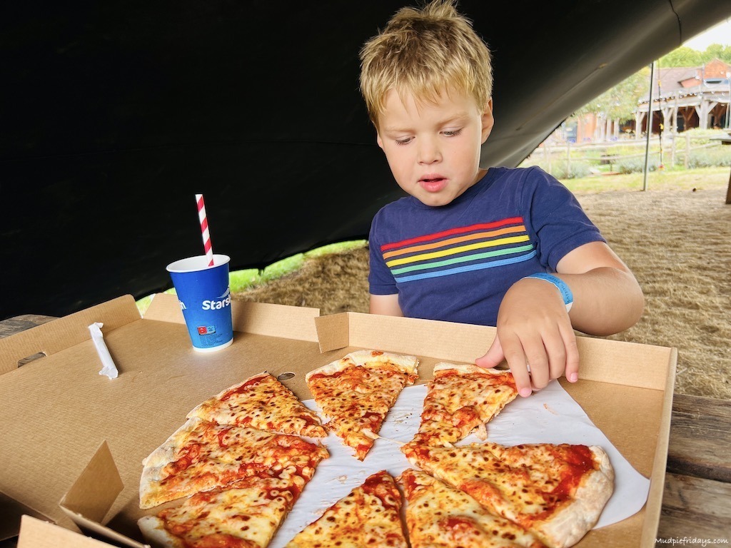 Harry eating pizza at the pizza cottage