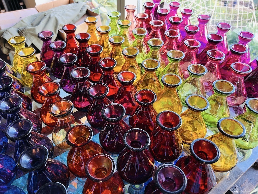 the different coloured glass bottles in the gift shop at Sarah ravens garden Perch hill