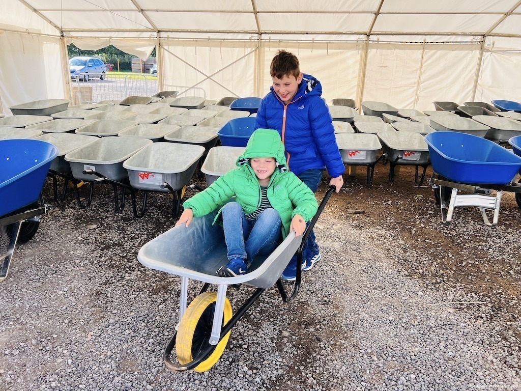 Boys picking out a wheelbarrow