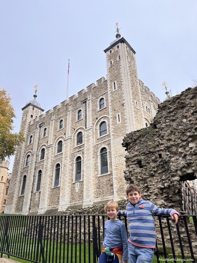 The boys outside with white tower at the tower of london