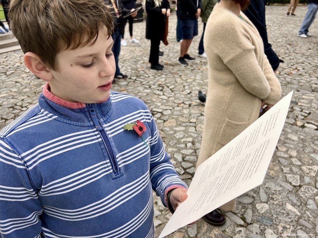 Charlie reading the order of service at the rememberance day service