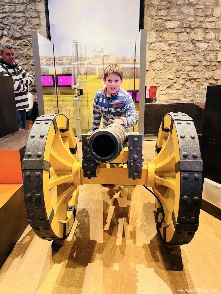 Charlie loading a canon - tower of london with kids