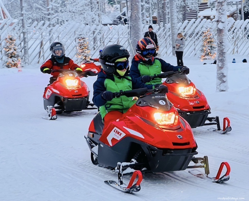 The boys on snowmobiles at Santa Claus Village Rovaniemi - lapland bucket list