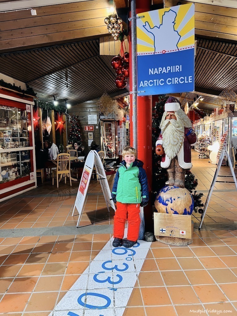 Harry crossing the arctic circle inside the information centre at Santa Claus VIllage Rovaniemi