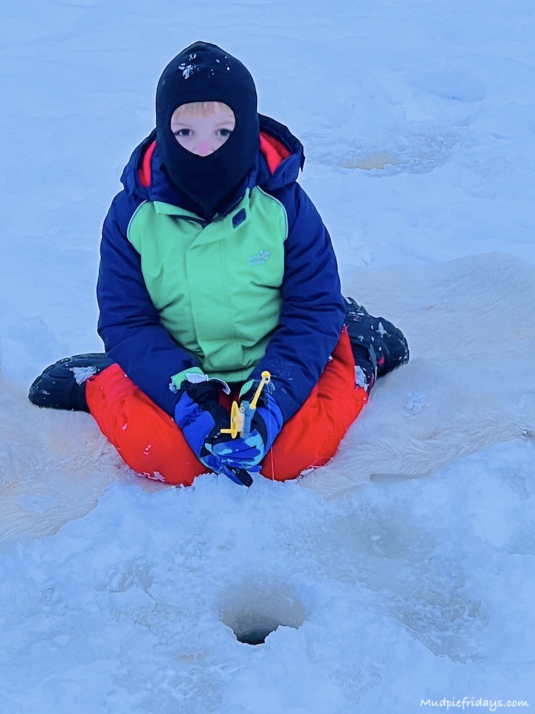 Harry trying ice fishing during our lapland in winter break