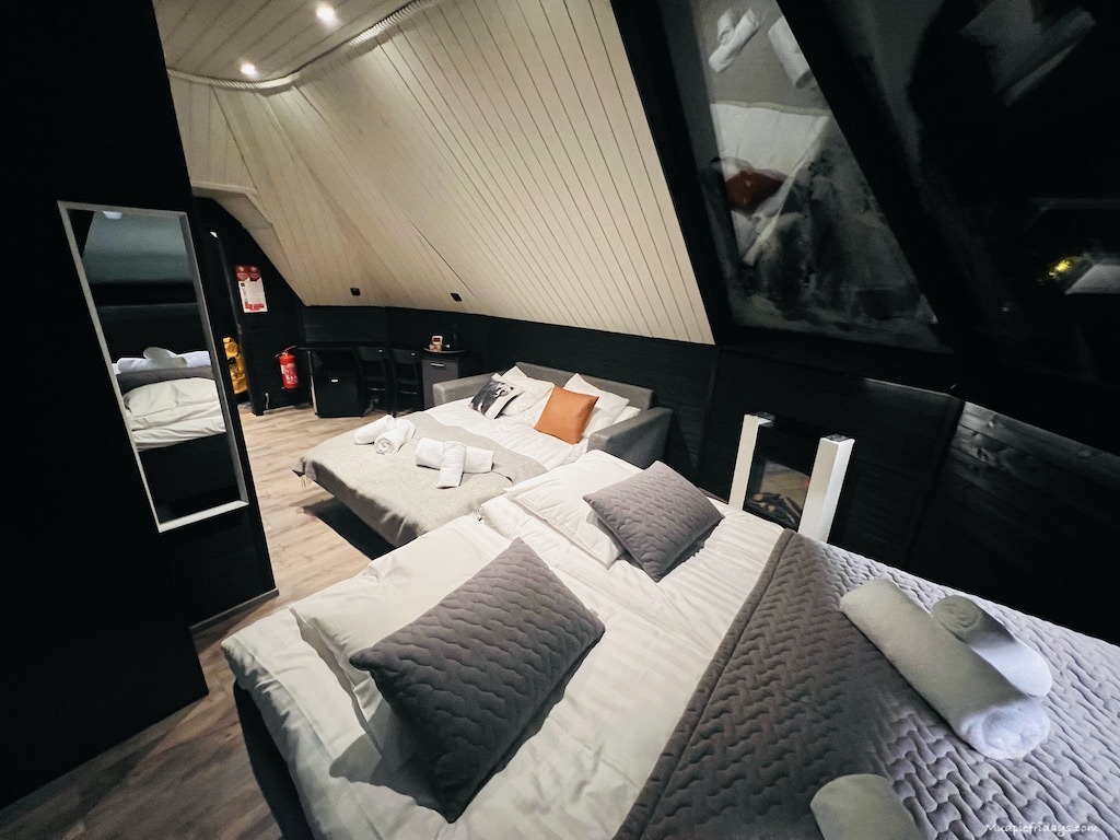 Inside the bedroom of the Aurora Cabin Glass Igloos at Apukka Resort Rovaniemi set up for two adults and two children