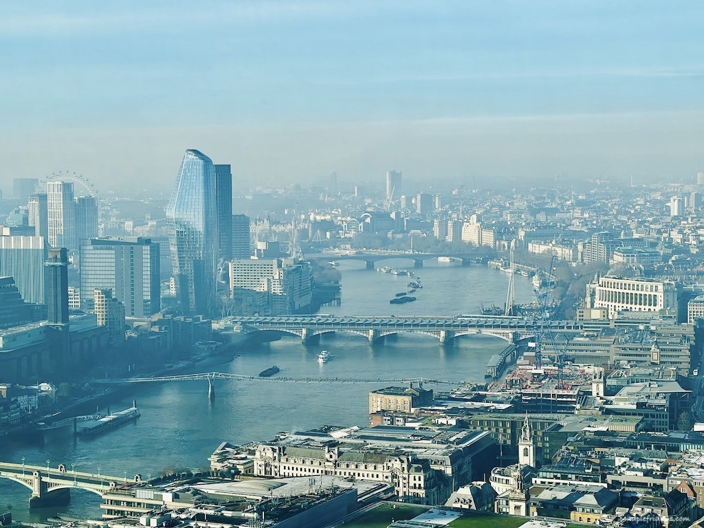 views across London and the River Thames in the hazy sunshine from the walkie talkie building
