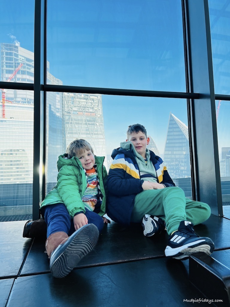 the boys with the London skyscrapers behind them from the walkie talkie building