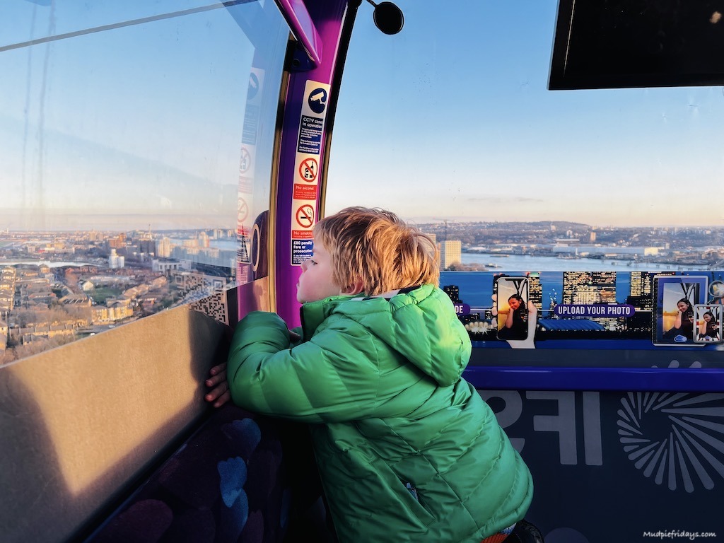Harry looking out of the cable car North Greenwich window at the views below
