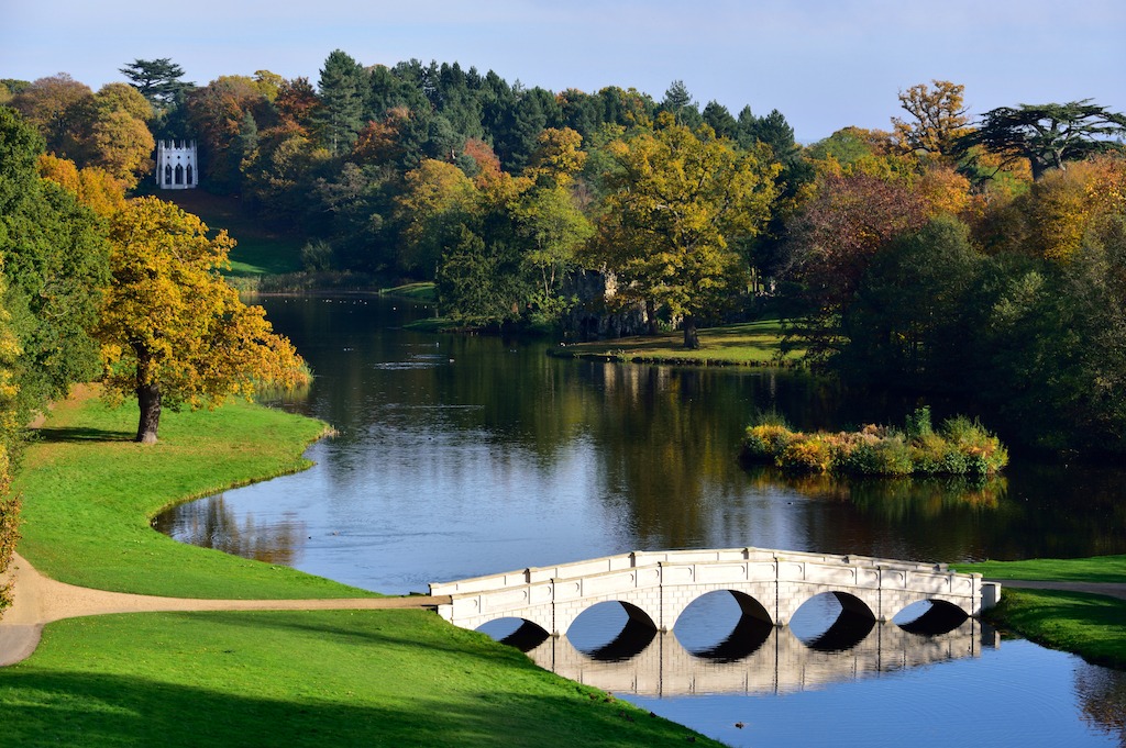 Painshill Park in Cobham, Surrey, England is an 18th century landscaped park, featuring the 5-arched bridge and in the distance a Gothic Temple.
