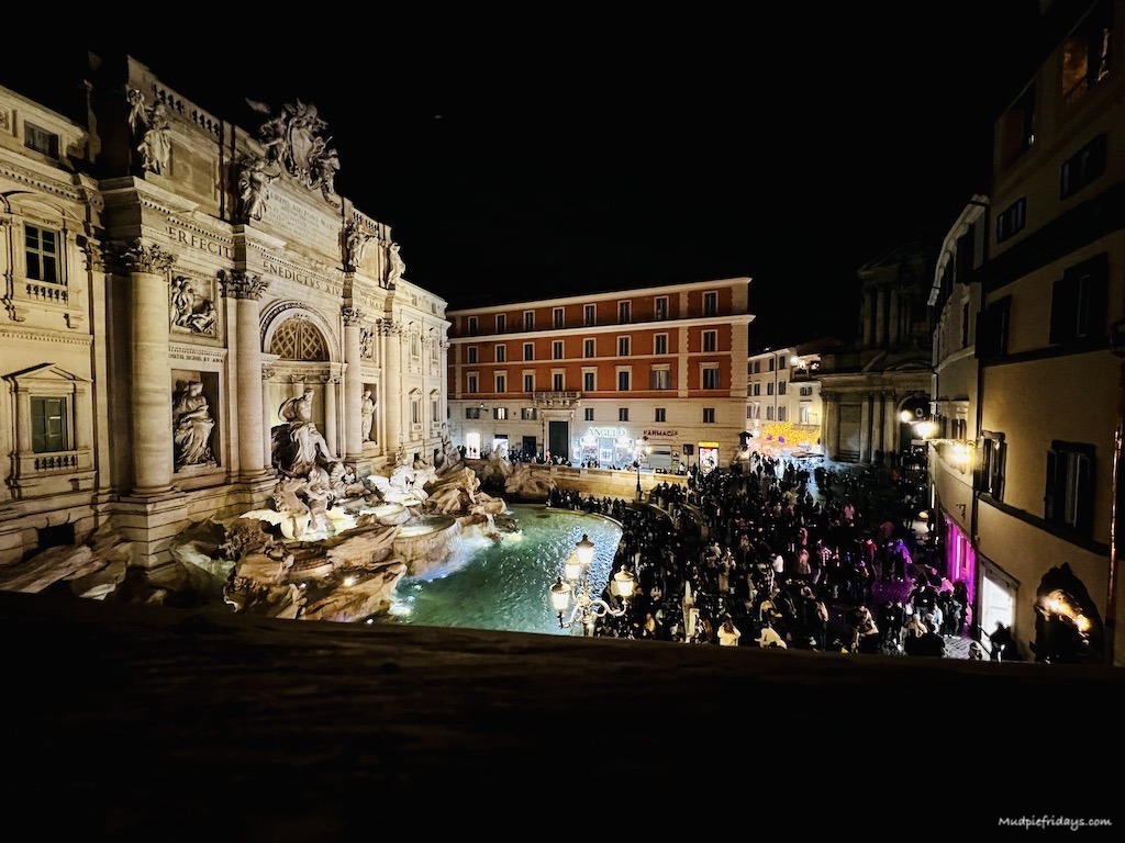 Looking at the Trevi fountain from the Trevi airbnb in the evening when it is still really busy 
