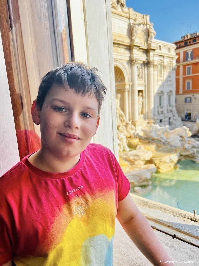 Charlie in the apartment with the Trevi fountain in the background
