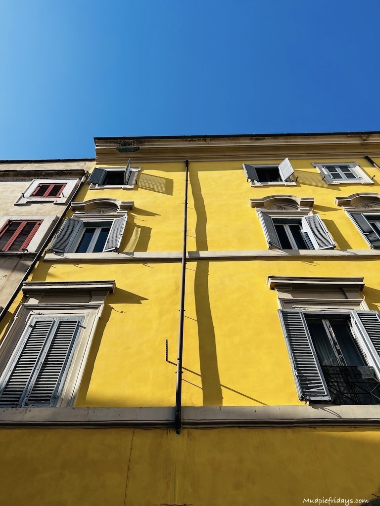 Looking up the outside of the Trevi apartment in Rome the top windows are the apartment near the Trevi fountain