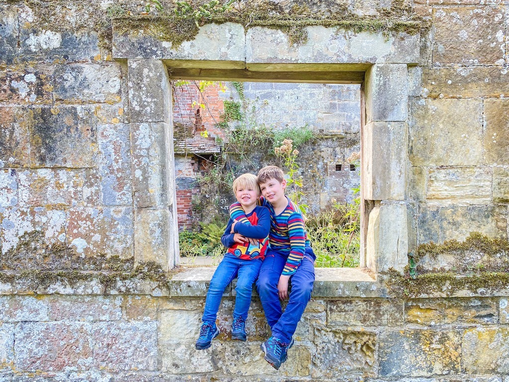 The boys sitting in a stone window together