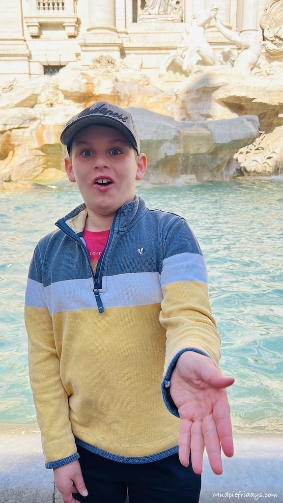 Throwing a coin in the Trevi fountain