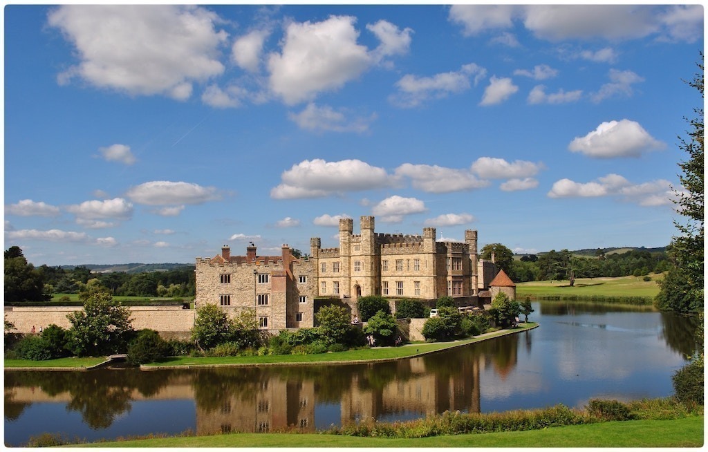 leeds castle with the reflection in the lake on a sunny day