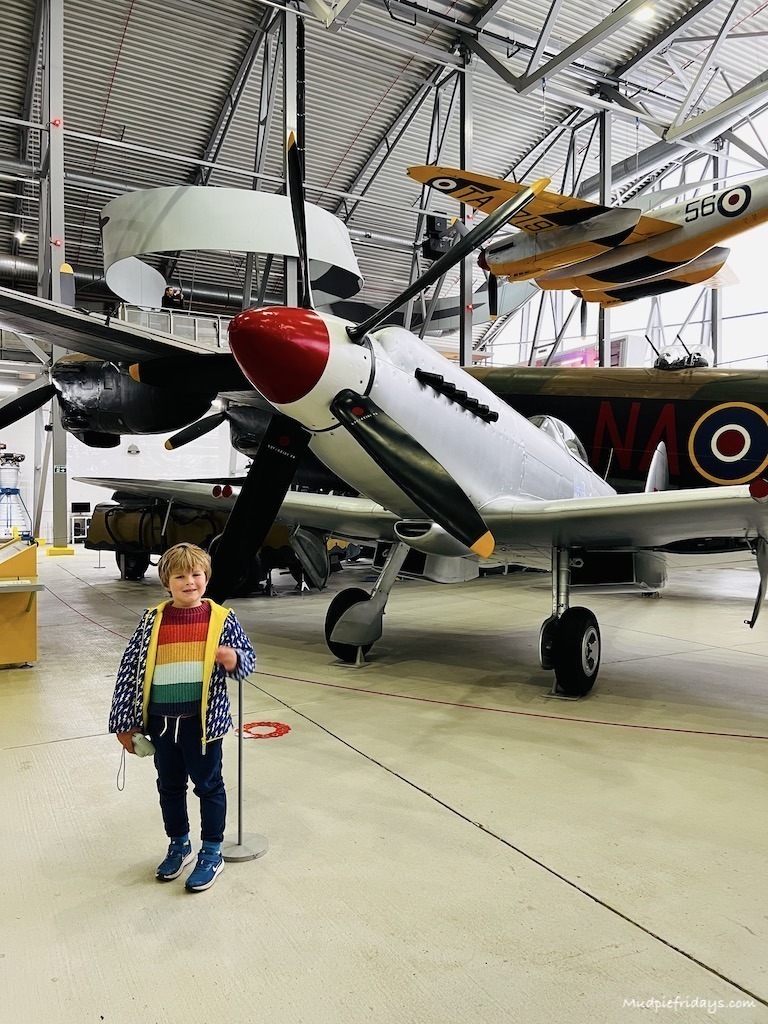 Harry in front of a silver spitfire 