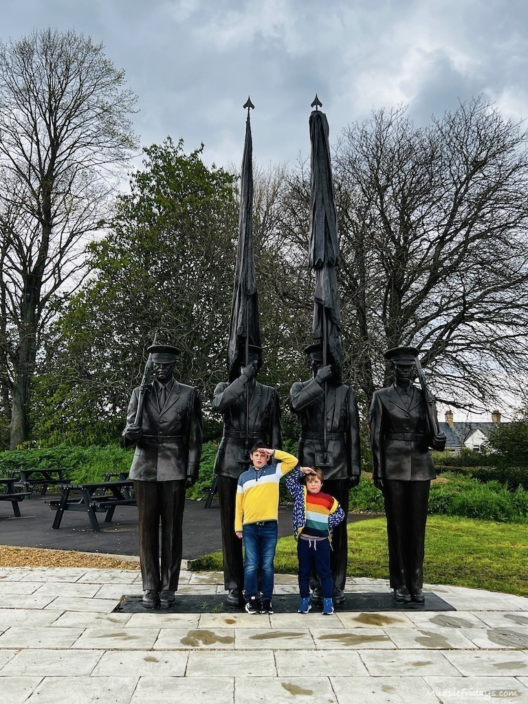The boys in front of the American memorial statue at Duxford