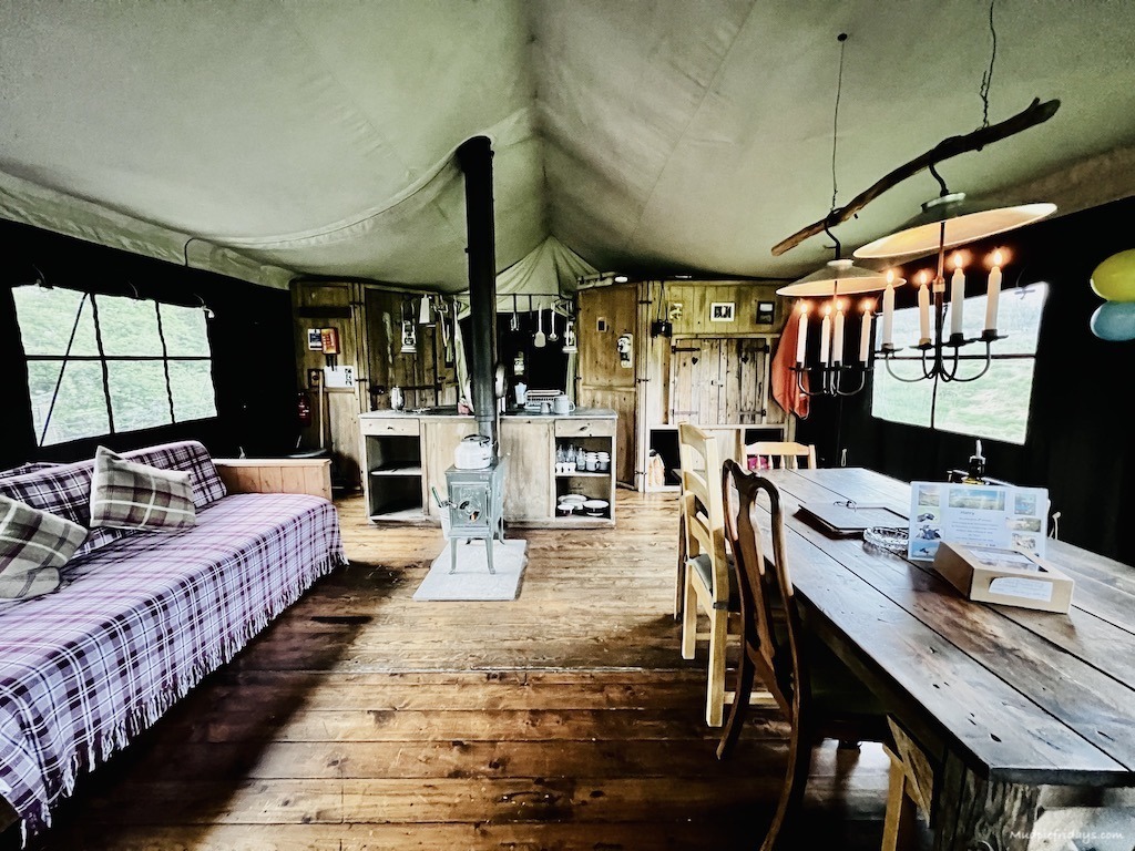 Inside a Feather Down Farms glamping safari tent with stove