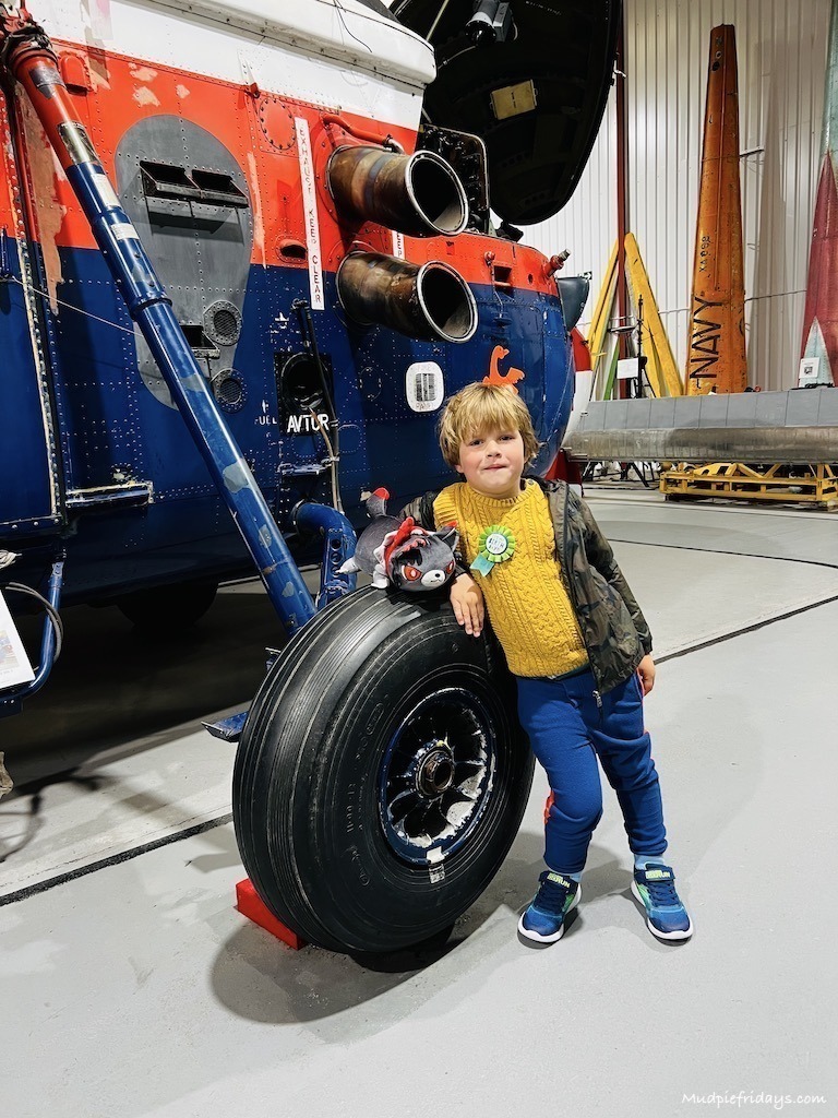 Harry standing in front of a helicopter wheel