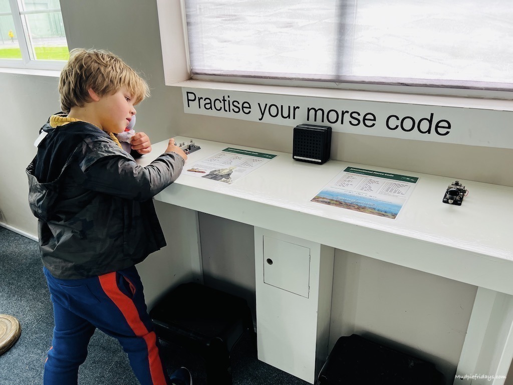 Harry learning all about morse code in the interactive area of the air museum somerset