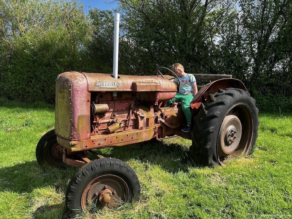 Harry on an old tractor as play equipment