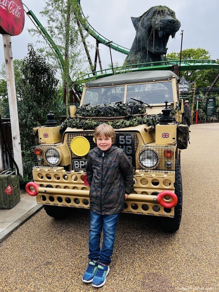Harry posing for a picture in front of Jumunji jeep