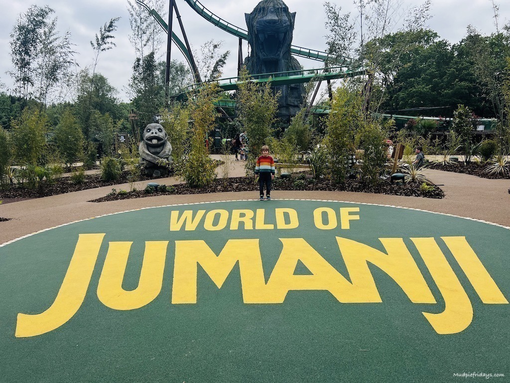 World of Jumanji Chessington World of Adventures - harry standing in front of the sign