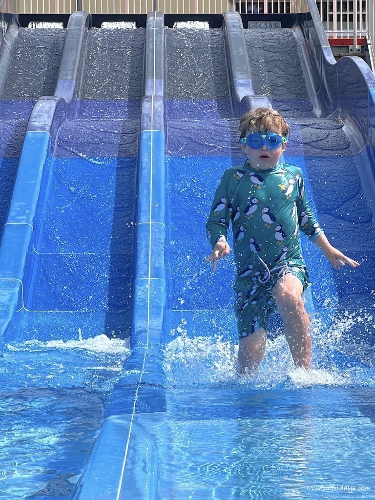 Harry playing on the splash slides
