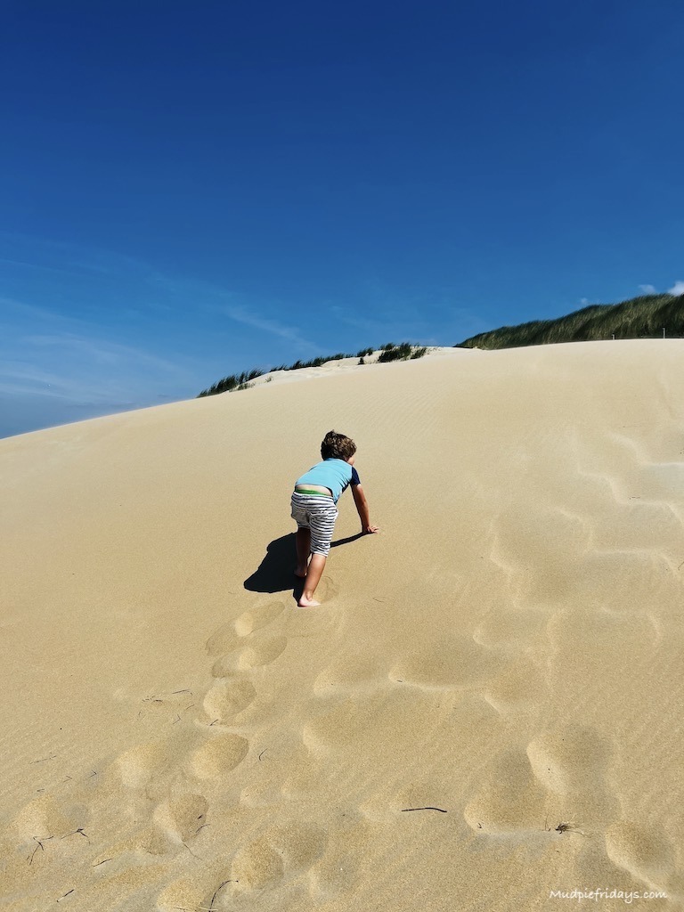 climbing sand dunes at Wassenaar Slag Beach